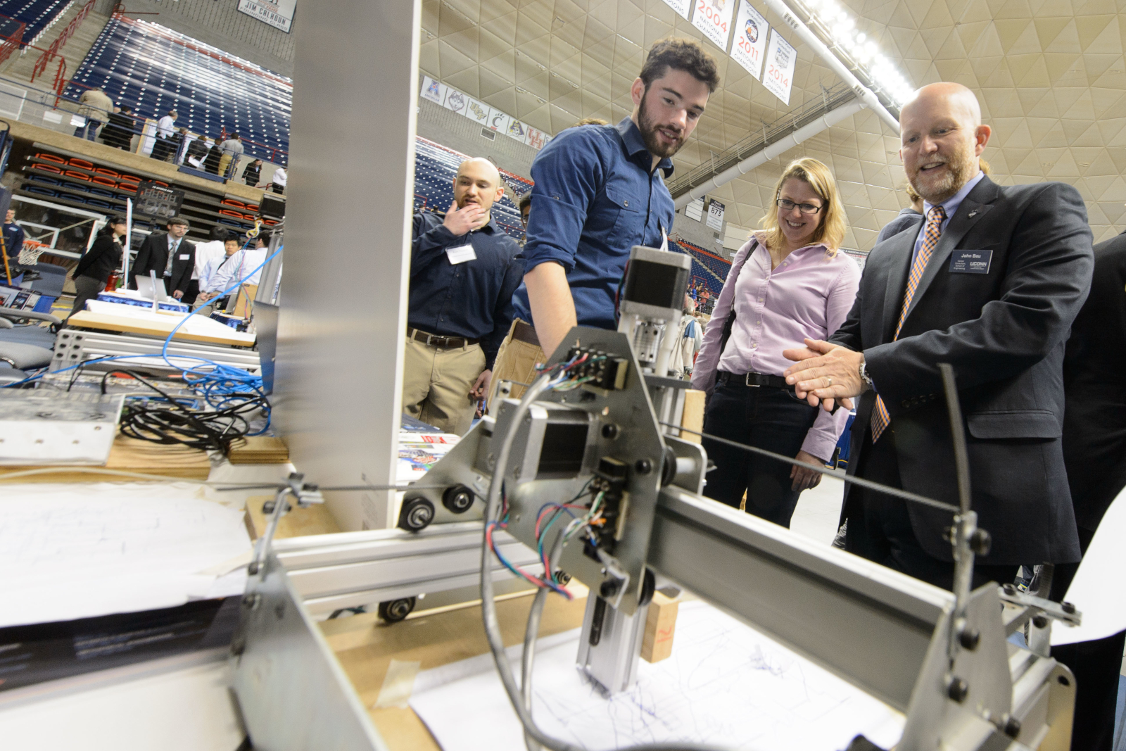 Dillon Jones '16 (ENG), left, talks with John Bau, director of the center for career development about a modular CNC machine with an open source web interface during the School of Engineering Senior Design Expo held at Gampel Pavilion on May 1, 2015. (Peter Morenus/UConn Photo)
